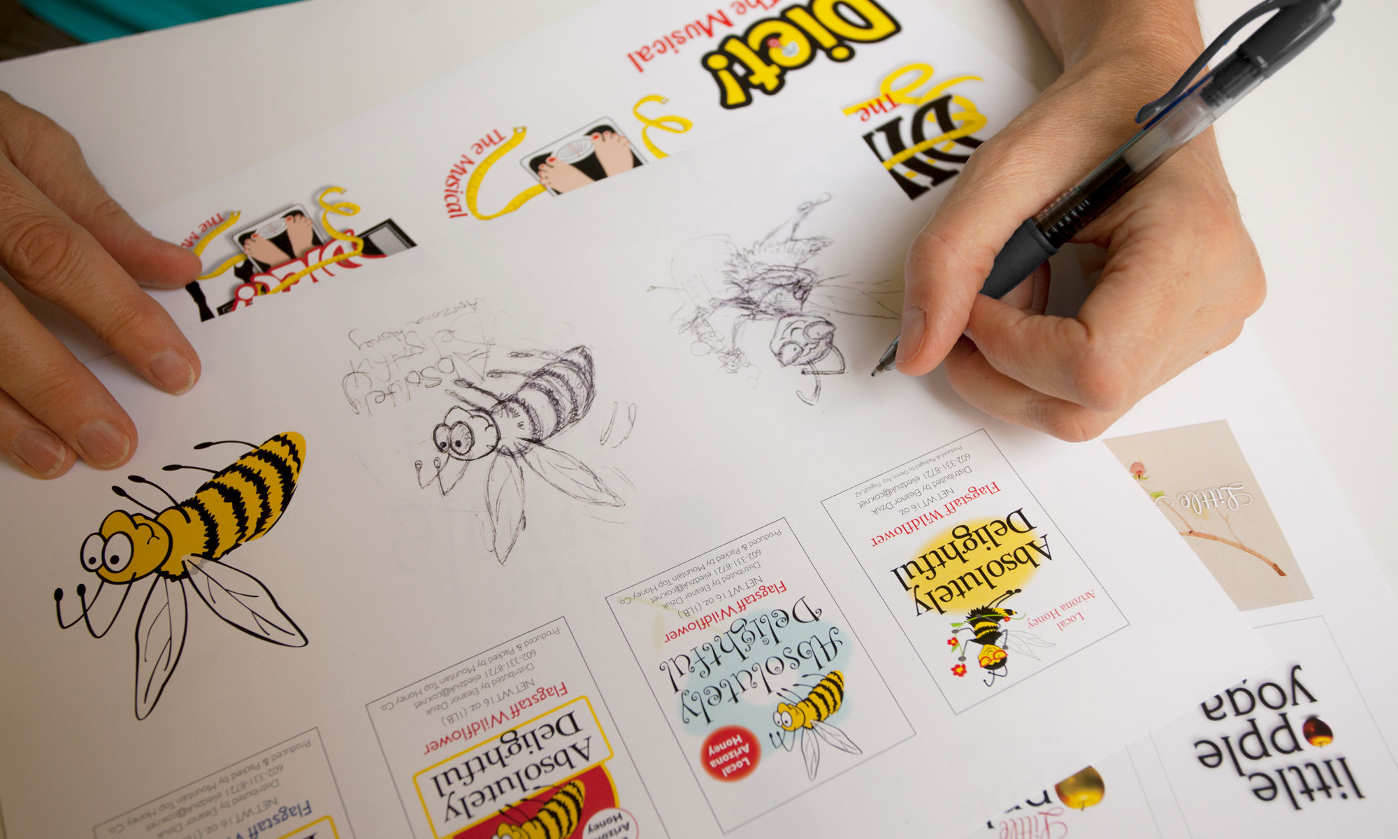 artist drawing a girl bee logo